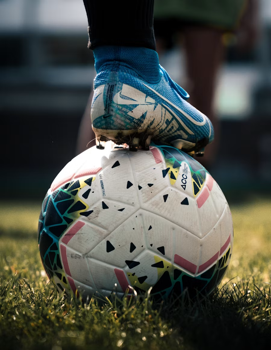 Player resting a boot on the ball before a focused training drill